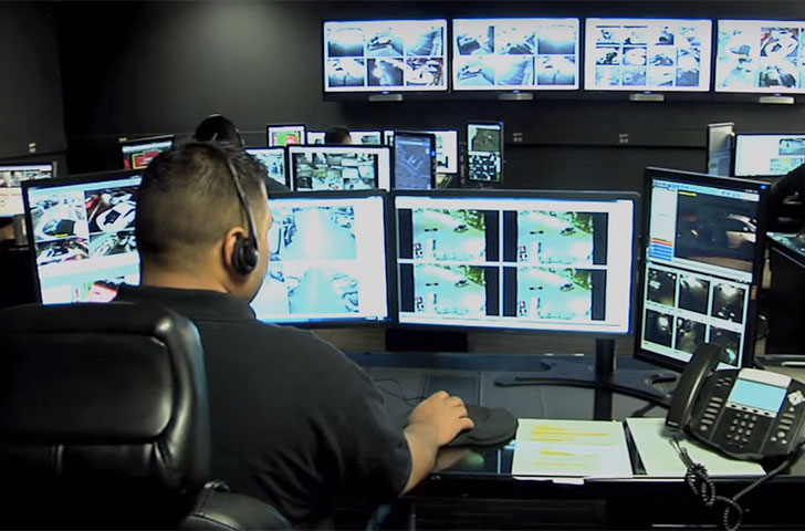 Elite_ISI_Command_Center.jpg A man sits in front of many computer screens showing points about logistics and transportation
