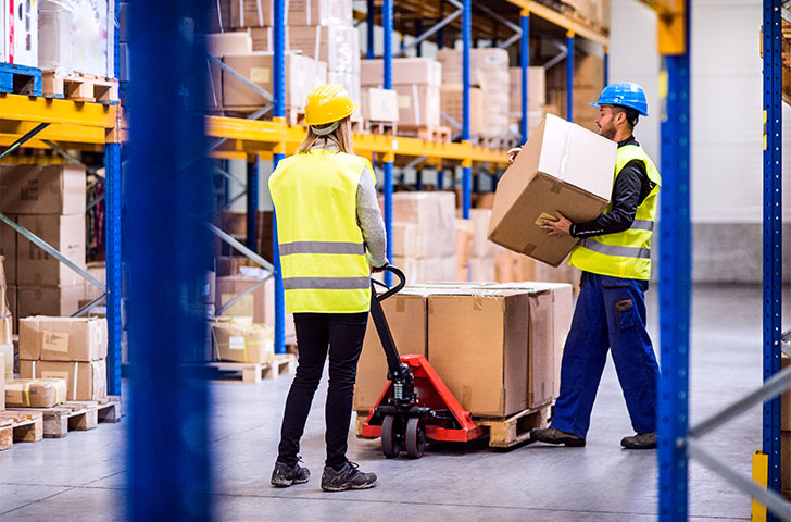 young-workers-in-a-warehouse-2021-08-26-12-07-50-utc.jpg Workers moving items in a modern warehouse