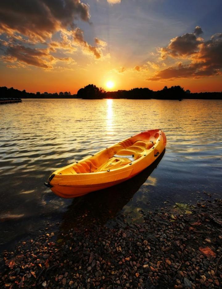 Photo of an emply canoe of a river in St. Louis at sunrise