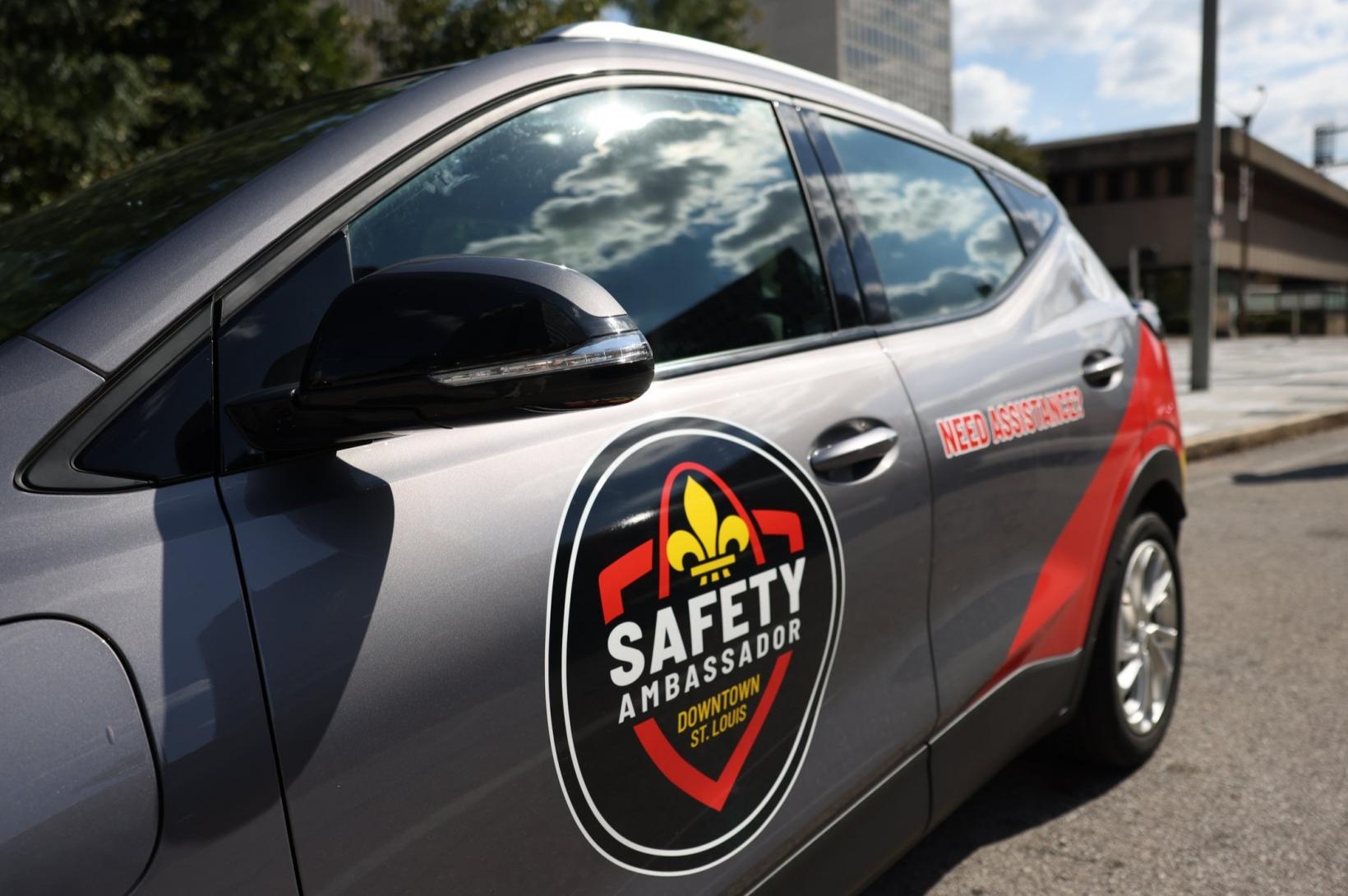 Downtown Public Safety Ambassador Program - newsroom A photo of a gray car wrapped in the Downtown Public Safety Ambassador program logo.