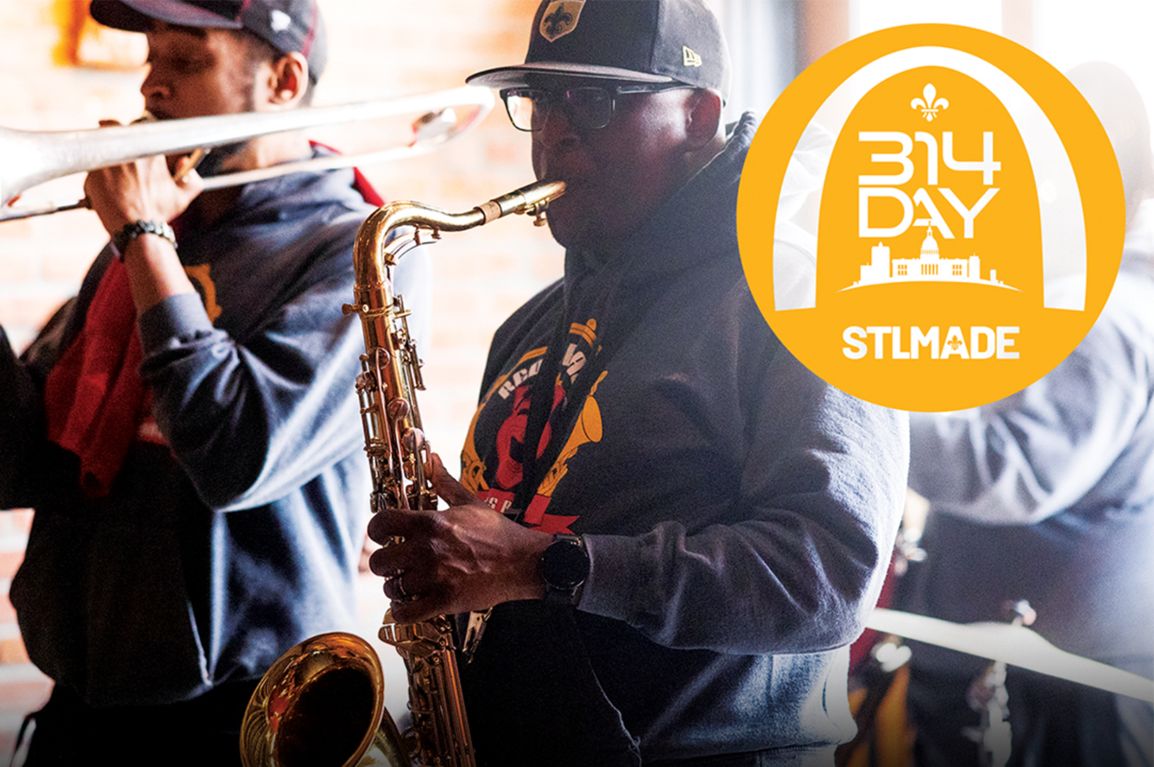 314 Day 2025 - Newsroom A photo of the Red and Black Brass Band with a yellow 314 Day and STLMade logo superimposed over the top.
