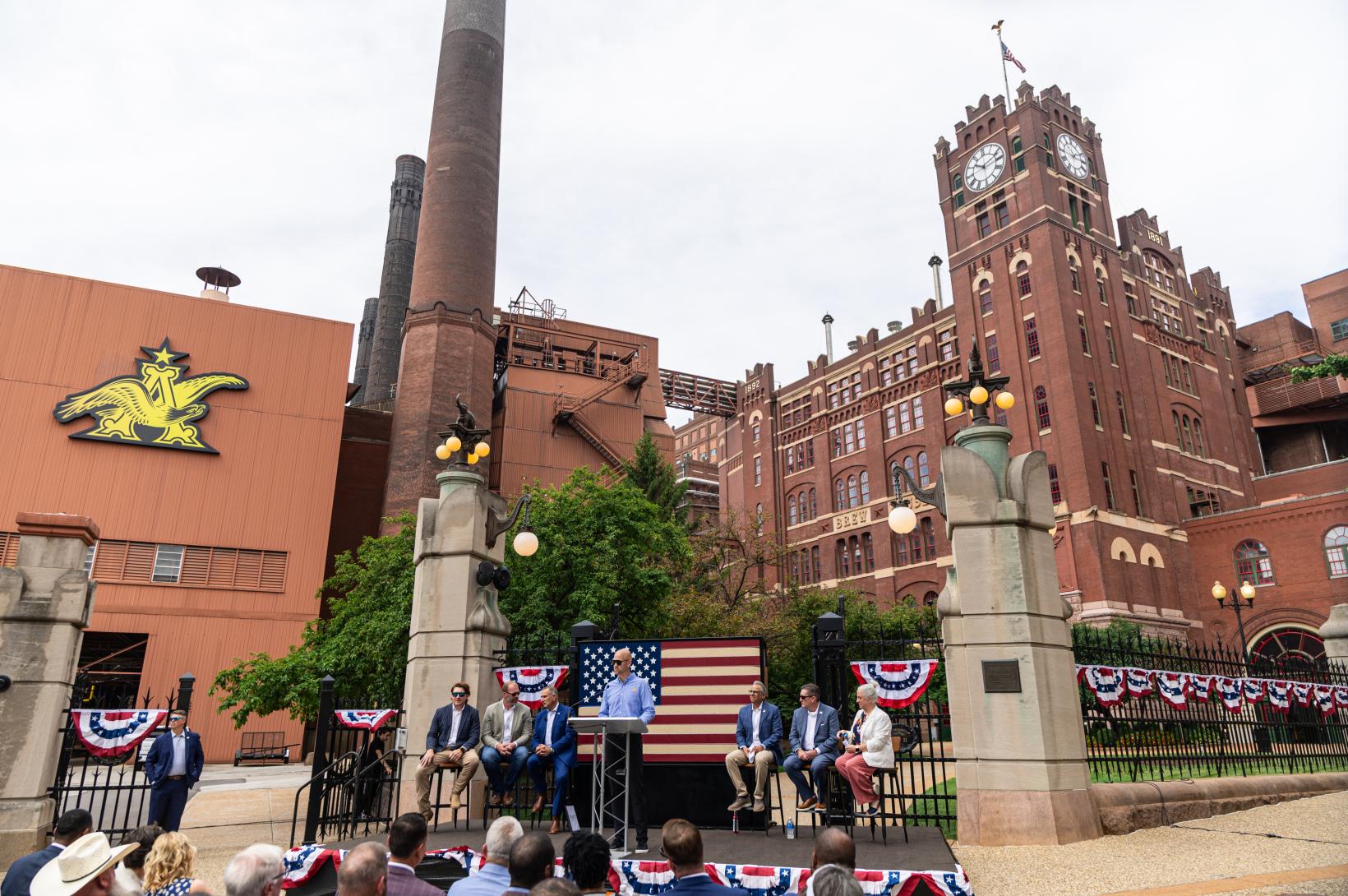 Celebrating the American Beer Act - July 2025 Leaders sit on a dias outside the Anheuser-Busch Brewery in St. Louis Missour.