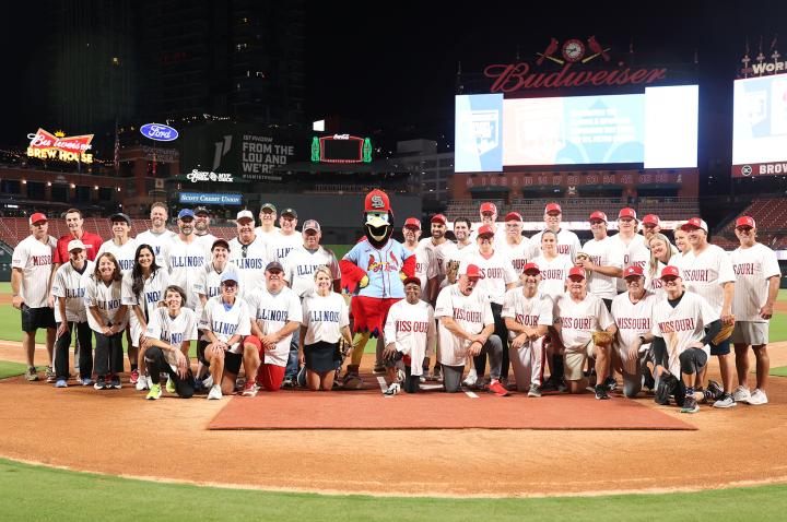 2025 Bi-State Softball Showdown players gather on the field at Busch Stadium.