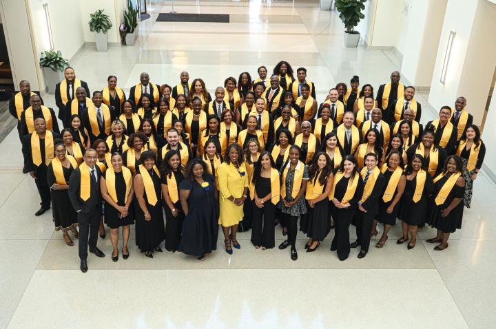The 19th cohort of the Fellows Experience poses for a photo during their graduation at Edward Jones