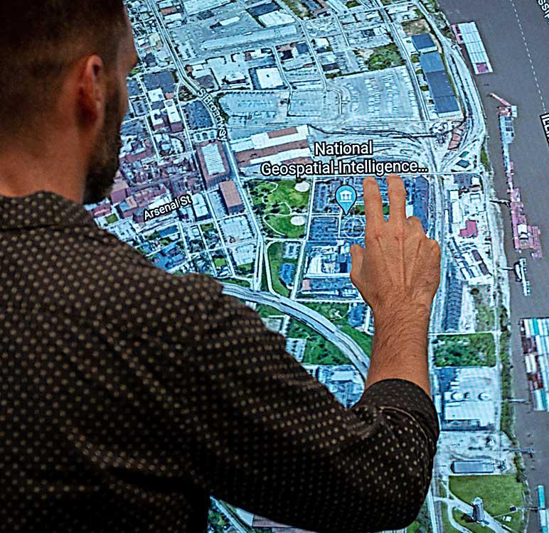 Photo of Andy Dearing using a touch-sensitive geospatial map screen